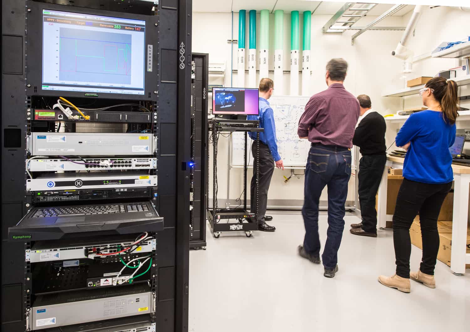 January 14, 2016 - Brian Miller, Maurice Martin, Randy Hunsberger, and Ivonne Pena, with the Cyber-Physical Systems Center, work through a scenario in the NREL Cyber Test Bed at the ESIF. January 14, 2016 - Brian Miller, Maurice Martin, Randy Hunsberger, and Ivonne Pena, with the Cyber-Physical Systems Center, work through a scenario in the NREL Cyber Test Bed at the ESIF.